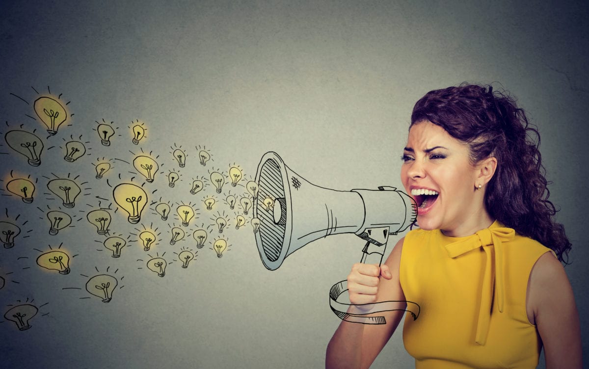 Business woman screaming out her ideas loud in megaphone