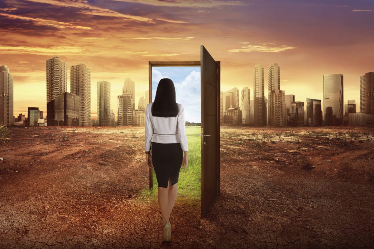 business woman walking to the open wooden door